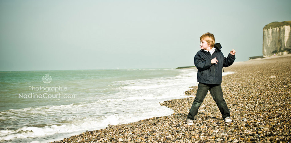 Seance-photo-Lifestyle-Enfant-Mer Lancer caillou dans la mer Normandie Plage galets Nadine Court Photo Lifestyle