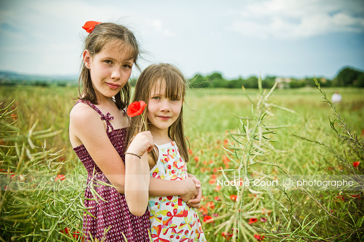 Photo d’enfants dans un champs de coquelicots